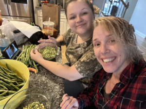 Elicia shelling peas at home